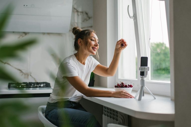 Female nutritionist blogger leads a live broadcast or video conference about the benefits of berries